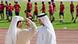 Two Emirates soccer fans talks to each other as Bayern Munich practise Two Emirates soccer fans talks to each other as Bayern Munich practise