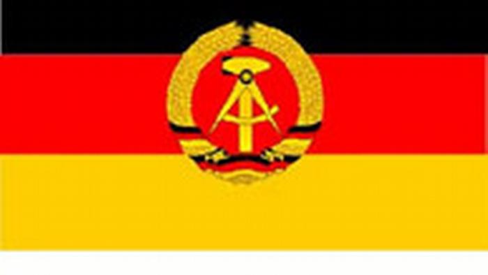 East German flag with black-red-gold with hammer and compass.