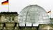 German flag flying at the German parliament, the Reichstag, a historic building topped by a modern glass dome German flag flying at the German parliament, the Reichstag, a historic building topped by a modern glass dome