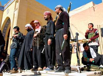 Iraqi Shiites, members of al-Mahdi Army militia stand guard outside the Al Kufa mosque in Kufa