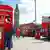 People in London's Parliment Square use a red phone box