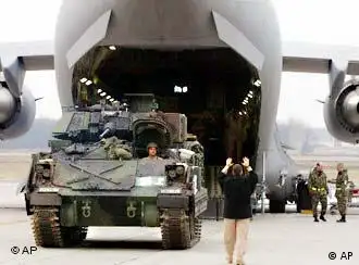 Getting ready to leave Germany: a tank loads onto a transport plane at the Ramstein air base.