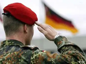 A German Bundeswehr soldier salutes the flag