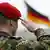 Bundeswehr soldier saluting with German flag in background