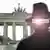 Spy in Berlin in front of Brandenburg Gate