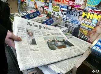 An unidentified person buys a copy of the New York Times at a newsstand Thursday, June 5, 2003 in New York. The New York Times' top two editors resigned Thursday after a tumultuous five weeks that began with the exposure of Jayson Blair's journalistic fraud and grew into a drumbeat of criticism of the management style at one of the world's most distinguished newspapers. (AP Photo/Akira Ono)