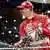 German Ferrari driver Michael Schumacher sprays champagne towards his team mechanics during a victory ceremony