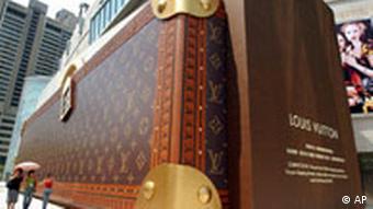 A large luggage looking statue of a Luis Vuitton briefcase