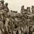 US Marines of the 1st Division line up for a prayer at their base outside Fallujah, Iraq