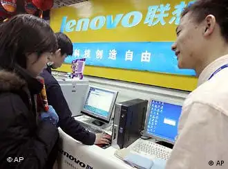 A Chinese salesman promotes Lenovo computers at a shop in Beijing, China, Friday, Jan 28, 2005. China's computer giant, Lenovo's deal to buy the personal computer division of IBM for a proposed US$1.75 billion is on hold pending a review by U.S. Committee on Foreign Investment after U.S. officials voice concerns over national security. (AP Photo/Ng Han Guan)