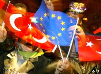 Women waving Turkish and EU flags