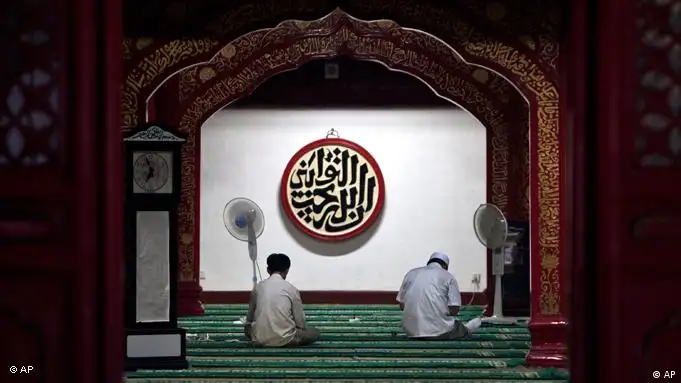 Chinese Hui Muslim men pray inside the Niujie Mosque on the first day of the Muslim holy month of Ramadan in Beijing Monday, Aug. 1, 2011. (AP Photo/Andy Wong)