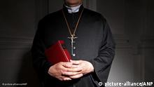 2010-05-28 ILLUSTRATION - Church, a priest in a church, holding a bible. c, his hands folded. This image was produced to illustrate the items about sexual abuse in the church, religious boarding schools and summer camps. ANP XTRA ROOS KOOLE pixel