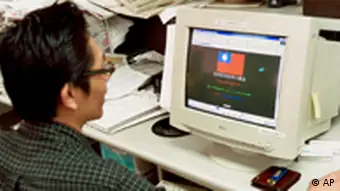An unidentified Taiwanese man accesses a Chinese government website on his computer via the internet showing a hacked page Monday, Aug. 9, 1999, in Taipei, Taiwan. A cyberwar has erupted between Taiwanese and Chinese computer hackers lending support to their governments battle for sovereignty over Taiwan. A Taiwanese hacked into a Chinese high-tech Internet site on Monday, planting on its webpage a red and blue Taiwanese national flag as well as an anti-Communist slogan:Reconquer, Reconquer, Reconquer the Mainland. (AP Photo/Wally Santana)