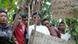 Villagers protest with signs against the international visitors Villagers protest with signs against the international visitors