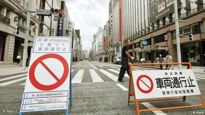 A street on Ginza shopping district is blocked during a disaster drill which was held on the assumption that an inland earthquake happened on National Disaster Prevention Day in Tokyo, Thursday, Sept. 1, 2011