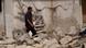 Libyan man in front of destroyed house Libyan man in front of destroyed house
