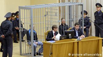 The two accused in a cage in court