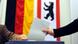 Hands voting against a background of Berlin's emblem Hands voting against a background of Berlin's emblem