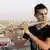 A National Youth Orchestra of Iraq flutist plays on a rooftop