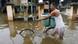 A Cambodian man walks with his bicycle though a flooded street at a village along the Mekong River A Cambodian man walks with his bicycle though a flooded street at a village along the Mekong River
