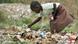 A little girls is looking through a trash heap for food in Zimbabwe A little girls is looking through a trash heap for food in Zimbabwe