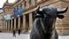 A statue of a bull in front of the German stock exchange building in Frankfurt A statue of a bull in front of the German stock exchange building in Frankfurt