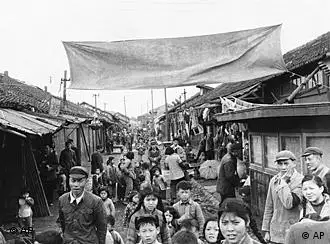 Meaningful tableau is presented by children and old houses, June 11, 1961 in Shanghai. Although a guide said new housing was being built for them, more than fifty percent of the people still live in shacks like this. (AP Photo)