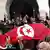 epa02623358 Tunisians stand hold a Tunisian national flag as they celebrate the dissolution of the former ruling party Constitutional Democratic Rally (RCD) by a Tunisian court, in front of the justice Place in Tunis, Tunisia, 09 March 2011. The party had been suspended from official activities in February 2011 by the interior ministry after former president Ben Ali fled abroad on January 14 at the height of a popular uprising to overthrow his autocratic regime. EPA/STRINGER +++(c) dpa - Bildfunk+++