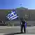 A protester waves a Greek flag in Athens