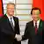 German President Christian Wulff, left, is welcomed by Japanese Prime Minister Yoshihiko Noda