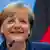 Bundeskanzlerin Angela Merkel (CDU) laechelt am Donnerstag (27.10.11) in Bruessel in Belgien auf einer Pressekonferenz nach dem EU-Gipfel zur Euro-Rettung. Durchbruch im Morgengrauen: Die Eurozone und die Banken haben sich in der Nacht zum Donnerstag auf einen Schuldenschnitt von 50 Prozent fuer Griechenland geeinigt, der den Hellenen wieder auf die Beine helfen soll. In die Gipfelerklaerung wurde das Ziel festgeschrieben, dass die Schuldenlast Athens bis 2020 auf ertraegliche 120 Prozent der Wirtschaftskraft zurueckgefahren wird. (zu dapd-Text) Foto: Geert Vanden Wijngaert/AP/dapd