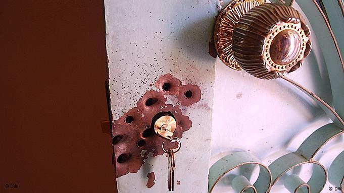Bullet holes on a door in Bani Walid . (Photo: Karlos Zurutuza / DW)