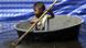 A Thai boy paddles along a flooded area in Bangkok A Thai boy paddles along a flooded area in Bangkok