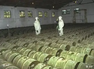 Two Russian soldiers make a routine check of metal containers with toxic agents at a chemical weapons storage site in the town of Gorny, 124 miles (200 kms) south of the Volga River city of Saratov, Russia in this May 20, 2000, photo. Russia plans to start dismantling the world's largest chemical weapons stockpile in 2001, but will need massive Western help to keep up the costly process. (AP Photo)
