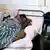 A Togolese woman with AIDS in a hospital bed.