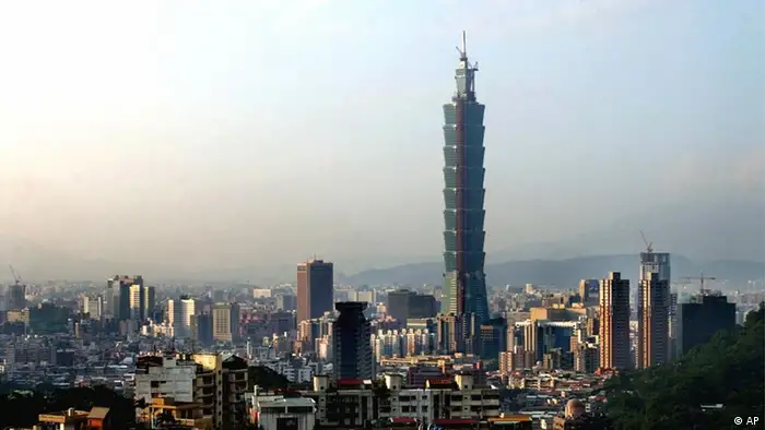 Taipei 101, the world's tallest skyscraper standing at 1,676-foot-tall, is seen from the fringes of Taipei, Thursday, Nov. 13, 2003. The main shopping mall in the lower levels of the building will be open to the public which is expecting a record turnout. The building is approximately 165 feet taller than the world's former highest office building, the Petronas Towers in Kuala Lumpur, Malaysia. The highest freestanding tower remains the CN Tower, a 1,815-foot communications structure and outlook point in Toronto. (AP Photo/Wally Santana)