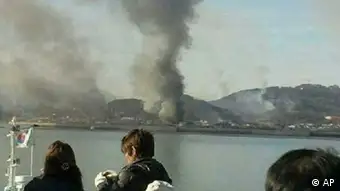Smoke is seen at Yeonpyeong island near the border against North Korea, in South Korea, Tuesday, Nov. 23, 2010. North Korea shot dozens of rounds of artillery onto the populated South Korean island near their disputed western border Tuesday, military officials said, setting buildings on fire and prompting South Korea to return fire and scramble fighter jets. (AP Photo/Yonhap) KOREA OUT