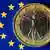 Italian euro coin on an EU flag