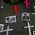 Crosses and pictures of people killed or abducted by alleged drug gangs are placed on a sidewalk during a protest to demand peace and justice in Mexico City.
