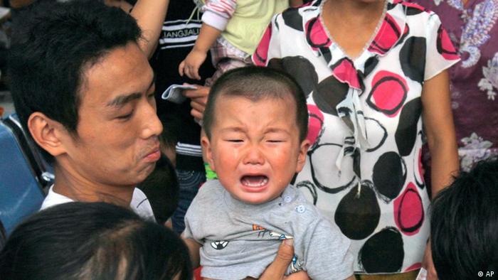 A child cries as he waits for ultrasonic scan to detect for problems related to consuming tainted milk formula at a hospital in Shijiazhuang, northern China's Hebei province, Thursday, Sept. 18, 2008. (AP Photo/Ng Han Guan)