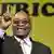A smiling Jacob Zuma with the word Africa behind him
