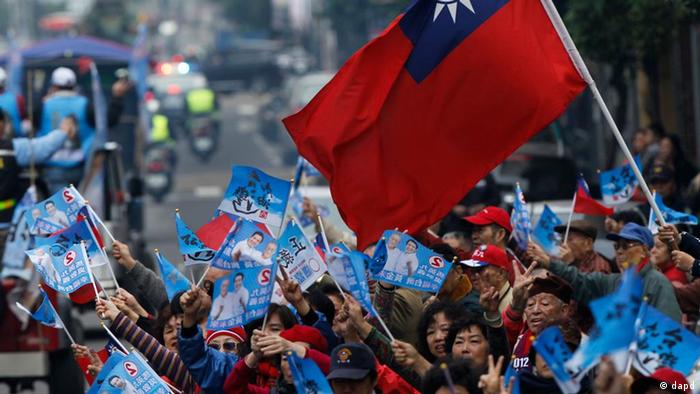 Supporters of Taiwan's President and presidential candidate Ma Ying-jeou wave flags during an election rally Tuesday, Jan. 10, 2012 in New Taipei City, Taiwan. Taiwan will hold its presidential election on Jan. 14, 2012.(AP Photo/Vincent Yu)