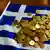 Pile of euro coins on a Greek flag