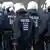 Rheinland-Pfalz/ Eine Gruppe Polizisten laeuft waehrend einer Demonstration gegen den Castor-Transport ueber ein Feld.