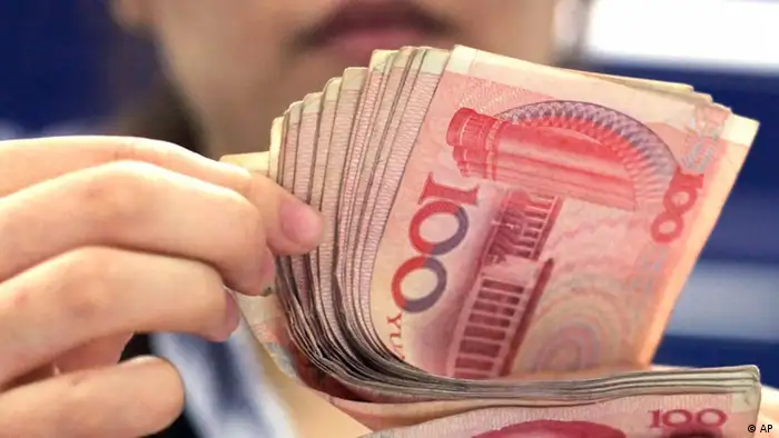 In this photo taken on Aug. 25, 2010, a bank clerk counts Chinese 100 Yuan notes in Shanghai. China's currency advanced to a fresh high against the U.S. dollar for the second straight day on Tuesday, Sept. 14, 2010 as U.S. lawmakers prepared for hearings on Beijing's foreign exchange policies. (AP Photo/Eugene Hoshiko)
