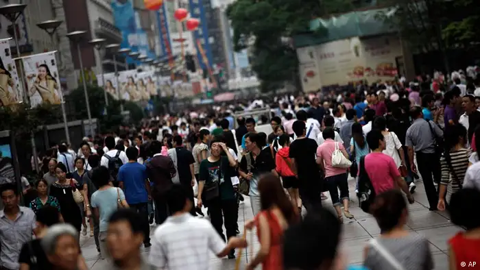 People walk on a shopping street on the Mid-Autumn Festival holiday, Monday, Sept. 12, 2011 in Shanghai, China. The Mid-Autumn Festival, also known as Moon Festival, falling on the 15th day of the 8th month of the lunar calendar will take place on Sept. 12 this year. (AP Photo/Eugene Hoshiko)