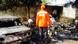 A rescue worker inspects the burnt-out wreckage of cars in Kano A rescue worker inspects the burnt-out wreckage of cars in Kano