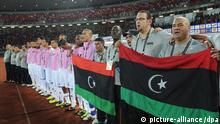 The Libyan bench sings the national anthem holding the Libyan flag ahead of the Africa Cup of Nations match between Equatorial Guinea and Libya in Bata, Equatorial Guinea, 21 January 2012. EPA/STR EDITORIAL USE ONLY