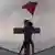 A Hindu protestor sets a Hindu flag atop a church in India's Orissa state